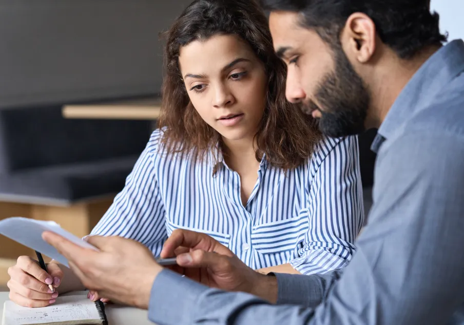 Two professionals reviewing documents and notes together